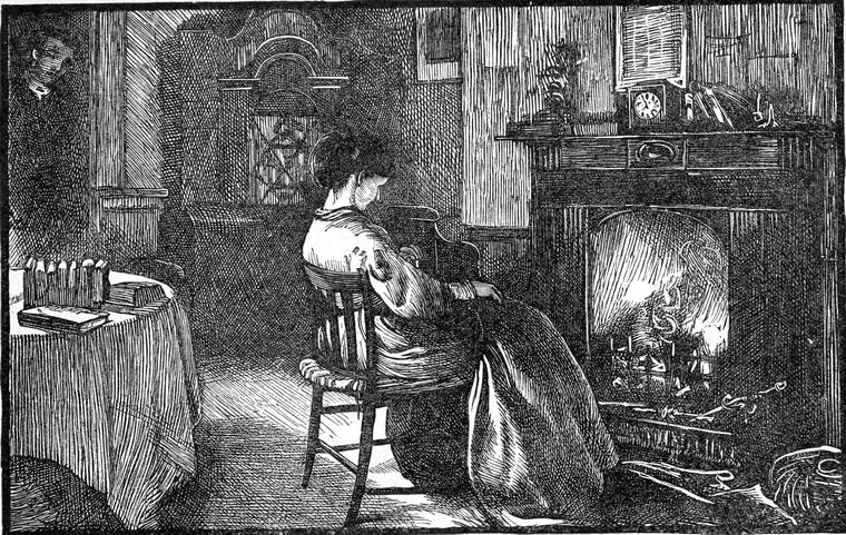 A woman sits alone by the fire in a quiet room, lost in thought.