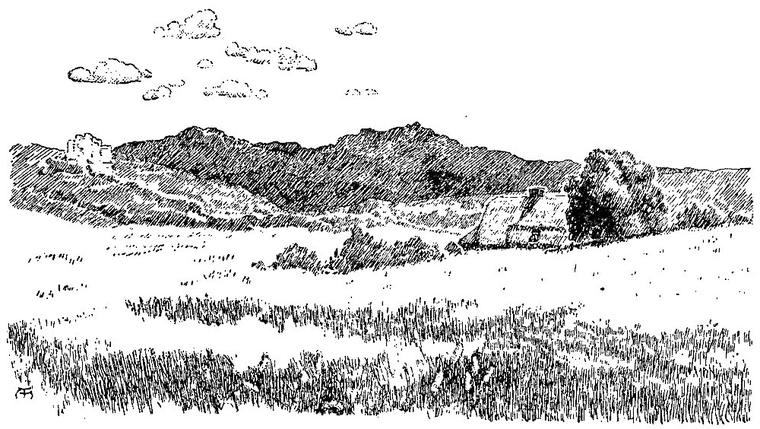 A grassy hilltop looks down on a valley, with a cottage among trees at right, a pale building on a far slope and mountains beyond.
