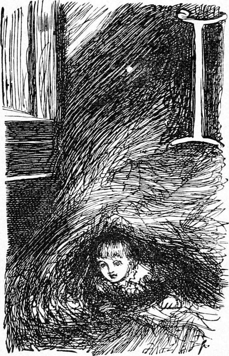 A small boy peeps out from under a great heap of hay in a dark loft.