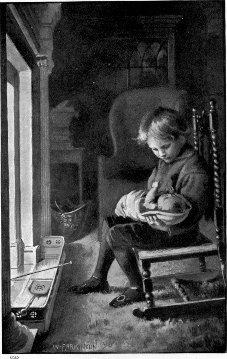 Clare sits in a chair by the window, cradling little Maly in his lap and talking softly to her.